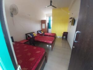 A photograph of a 3-sharing bedroom in a coliving pg.