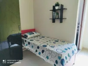 A photograph of a single sharing bedroom in a coliving pg.