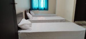 Photograph of a 3-sharing bedroom in a coliving pg.