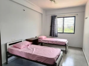 Photograph of a double sharing room in a coliving pg.