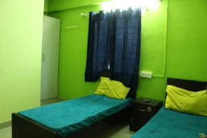 A photograph of a double sharing room in a coliving PG.