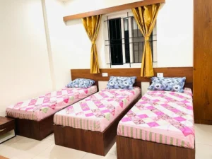 A photograph of a 3-sharing room in a coliving PG.