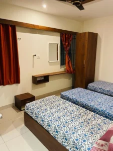 A photograph of a 3-sharing room in a coliving PG.
