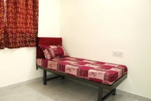 A photo of a single sharing room in a coliving PG in JP Nagar.