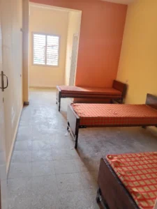 A photograph of a 3-bed sharing room in Maruthi PG.