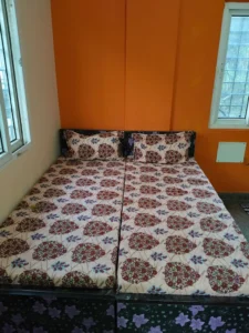 A photograph of a 2-bed sharing room in Maruthi PG.