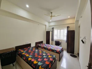 A photograph of a double sharing room in a coliving pg in Bannerghatta.